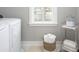 Well-organized laundry room with white washer/dryer and storage at 786 Clay Field Trl, Summerville, SC 29485