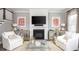 Inviting living room with a cozy fireplace, white seating, and stylish decor at 786 Clay Field Trl, Summerville, SC 29485