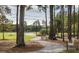 Peaceful park path with benches, surrounded by trees, greenery and serene views at 786 Clay Field Trl, Summerville, SC 29485