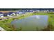 Scenic view of a community pond, surrounded by well-maintained lawns and beautiful homes at 786 Clay Field Trl, Summerville, SC 29485