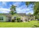 Backyard with green lawn, patio, grill, shrubs, and vinyl siding at 7896 Montview Rd, North Charleston, SC 29418