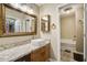 Well-lit bathroom with white basin sink, a framed mirror, and tile flooring at 7896 Montview Rd, North Charleston, SC 29418