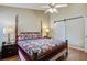 Inviting bedroom featuring a four-poster bed, ceiling fan, and access to bathroom at 7896 Montview Rd, North Charleston, SC 29418