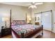 Relaxing bedroom with a four-poster bed, ceiling fan, and modern sliding door to the bathroom at 7896 Montview Rd, North Charleston, SC 29418