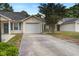 Exterior of home featuring a driveway and attached garage, complemented by lush greenery at 7896 Montview Rd, North Charleston, SC 29418