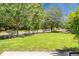 Street view of front yard with green lawn, shrubs, and street at 7896 Montview Rd, North Charleston, SC 29418