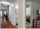 Hallway with a bathroom and laundry room on either side, and wood floors at 7896 Montview Rd, North Charleston, SC 29418