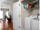 Laundry room with white washer and dryer, wire shelf with detergents and other items at 7896 Montview Rd, North Charleston, SC 29418