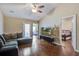 Open living room with a high ceiling, modern entertainment center, and view into the bedroom at 7896 Montview Rd, North Charleston, SC 29418