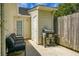 Exterior patio with grill, door to shed, bench with gray cushions, and wooden privacy fence at 7896 Montview Rd, North Charleston, SC 29418