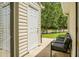 Exterior patio with door to shed and a bench with gray cushions at 7896 Montview Rd, North Charleston, SC 29418