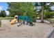 Community playground featuring a slide, climbing structures, and benches in a sand-filled area at 7896 Montview Rd, North Charleston, SC 29418