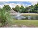 Picturesque pond with a fountain, a gazebo, and lush landscaping, perfect for relaxation at 7896 Montview Rd, North Charleston, SC 29418