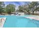 A swimming pool in a community with a pool house with picnic tables and a view of the surrounding trees at 7896 Montview Rd, North Charleston, SC 29418