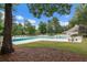 Large outdoor swimming pool with lounge chairs and sunbathing area, surrounded by trees and green space at 7896 Montview Rd, North Charleston, SC 29418