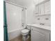 Bathroom featuring a tub/shower combo, toilet, and vanity with white painted cabinets at 7914 Dutch Ct, North Charleston, SC 29420