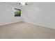 Spacious bedroom with neutral carpeting, ceiling fan and a bright window at 7914 Dutch Ct, North Charleston, SC 29420