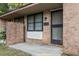 Inviting front entrance with brick facade, showing the house number and secure screen door at 7914 Dutch Ct, North Charleston, SC 29420