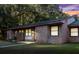 Charming single-story brick home featuring a well-maintained lawn and beautiful landscaping at 7914 Dutch Ct, North Charleston, SC 29420
