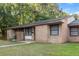 Charming single-story brick home featuring a well-maintained lawn and mature trees at 7914 Dutch Ct, North Charleston, SC 29420