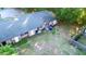 Aerial view of a brick home with a large backyard, privacy fence, and lush green trees at 7914 Dutch Ct, North Charleston, SC 29420