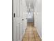 Hallway with neutral tile floors and multiple white paneled doors leading to other rooms at 7914 Dutch Ct, North Charleston, SC 29420