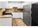 Efficient kitchen with white cabinets, tile countertops, and stainless steel appliances at 7914 Dutch Ct, North Charleston, SC 29420