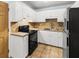 Functional kitchen featuring white cabinetry, tile countertops, and modern black appliances at 7914 Dutch Ct, North Charleston, SC 29420