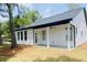Beautiful backyard with a covered porch, green grass, and wooded area at 8633 Connor Ct, North Charleston, SC 29406