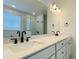 Modern bathroom with a large vanity, double sinks, and a glass-enclosed shower at 8633 Connor Ct, North Charleston, SC 29406