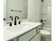 Bright bathroom features a shower-tub combination and modern vanity with black fixtures at 8633 Connor Ct, North Charleston, SC 29406