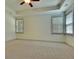 A serene bedroom boasts neutral carpeting and tray ceilings, complemented by natural light from the windows at 8633 Connor Ct, North Charleston, SC 29406
