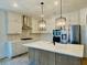 Modern kitchen with stainless steel appliances, a large island, and stylish pendant lighting at 8633 Connor Ct, North Charleston, SC 29406