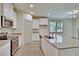 Bright kitchen features granite counters, stainless steel appliances, a spacious island, and ample cabinetry at 8633 Connor Ct, North Charleston, SC 29406