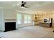 Spacious living room with a fireplace, tray ceilings, and seamless access to the kitchen at 8633 Connor Ct, North Charleston, SC 29406