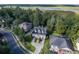 An aerial view of a home with a well-manicured lawn, lush trees, and river view at 8657 Refuge Point Circle Cir, Charleston, SC 29420