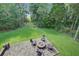 Aerial view of a brick patio with a cozy fire pit and seating, perfect for outdoor gatherings at 8657 Refuge Point Circle Cir, Charleston, SC 29420