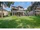 Large backyard featuring a well-manicured lawn, patio, and fire pit area for outdoor entertaining at 8657 Refuge Point Circle Cir, Charleston, SC 29420