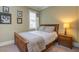 Cozy bedroom features wood bed frame, neutral colors, and natural light from the window at 8657 Refuge Point Circle Cir, Charleston, SC 29420