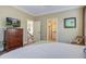 Comfortable bedroom features a TV, neutral colored walls, and lots of light at 8657 Refuge Point Circle Cir, Charleston, SC 29420