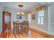 Elegant dining room featuring wood floors, chandelier lighting and window shutters at 8657 Refuge Point Circle Cir, Charleston, SC 29420
