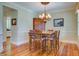 Elegant dining area with wooden table, chairs, chandelier, and hardwood floors at 8657 Refuge Point Circle Cir, Charleston, SC 29420