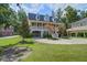 Charming two-story home with a spacious driveway, lush lawn and inviting front porch at 8657 Refuge Point Circle Cir, Charleston, SC 29420