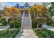 Inviting two-story home with grand front stairs, stylish porch, and well-manicured landscaping at 8657 Refuge Point Circle Cir, Charleston, SC 29420