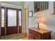 Welcoming foyer with frosted glass door, wooden floors, a staircase and an antique table at 8657 Refuge Point Circle Cir, Charleston, SC 29420