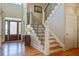 Stunning foyer features gleaming hardwood floors, staircase, and a beautiful front door at 8657 Refuge Point Circle Cir, Charleston, SC 29420