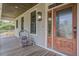 Charming front porch featuring wood flooring, chair seating and rustic outdoor lantern at 8657 Refuge Point Circle Cir, Charleston, SC 29420