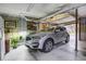 Clean garage space featuring a modern SUV, storage shelves, and well-lit environment at 8657 Refuge Point Circle Cir, Charleston, SC 29420