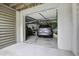 View of a spacious two car garage with vehicle and extra storage space at 8657 Refuge Point Circle Cir, Charleston, SC 29420