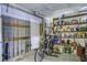Organized garage area with storage shelves, fishing poles, a bicycle, and a well-maintained door at 8657 Refuge Point Circle Cir, Charleston, SC 29420